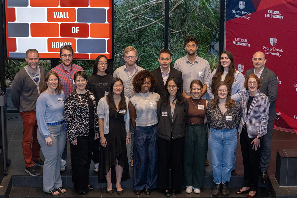 fellowship and scholarship recipients at the wall of honor event lined up for a group photo