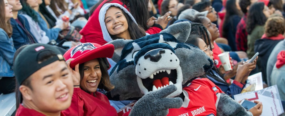 Mascot Wolfie with student in chairs