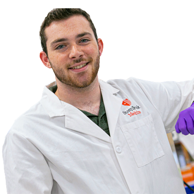 Student in Lab coat smiling