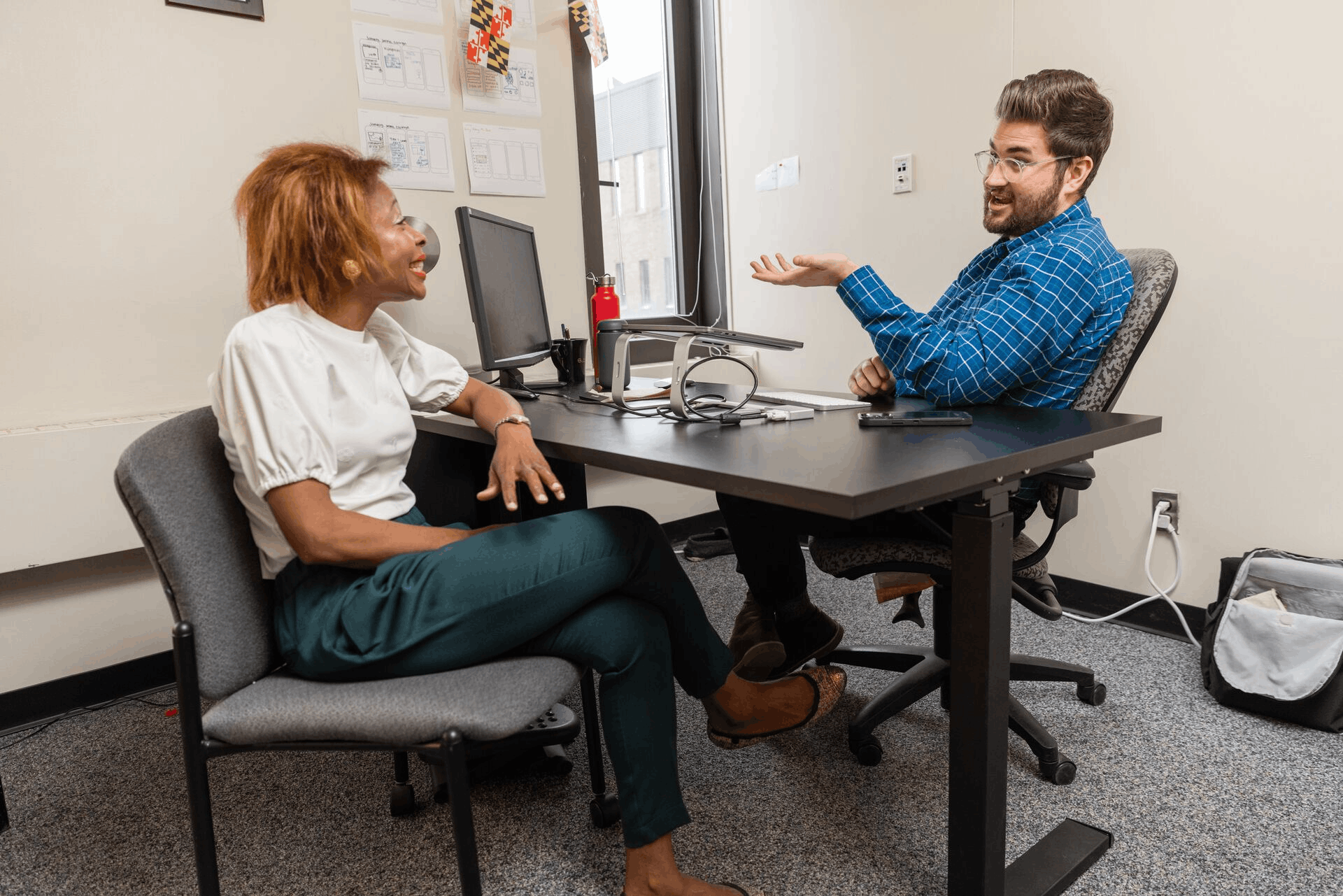Graduate student conversing with mentor.