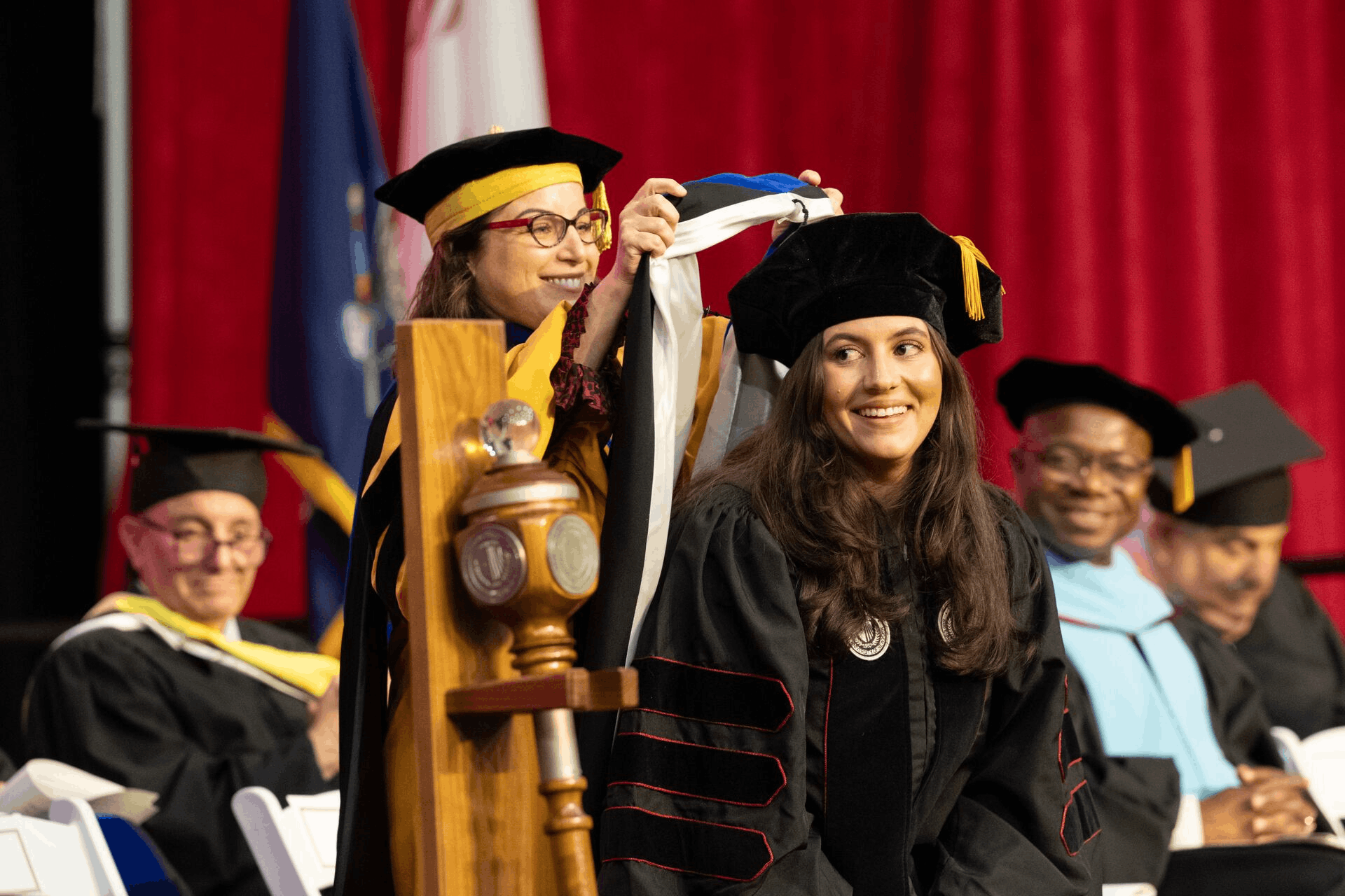 Graduate student at doctoral hooding ceremony