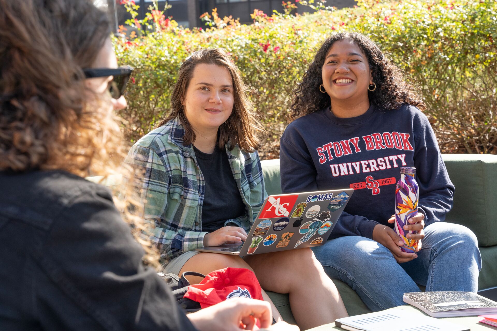 Stony Brook Students sitting and chatting outside
