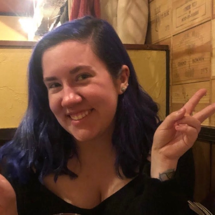 Veronica Peck Girl smiling and making a peace sign with one hand