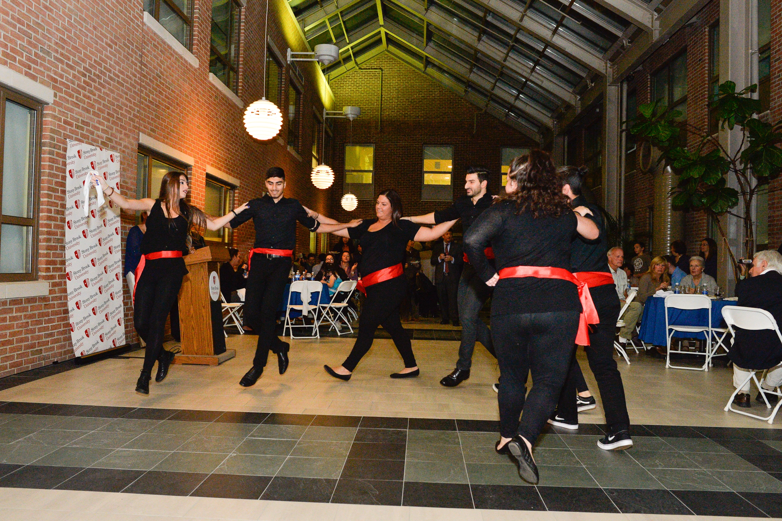 Seven students dancing at the opening ceremony.