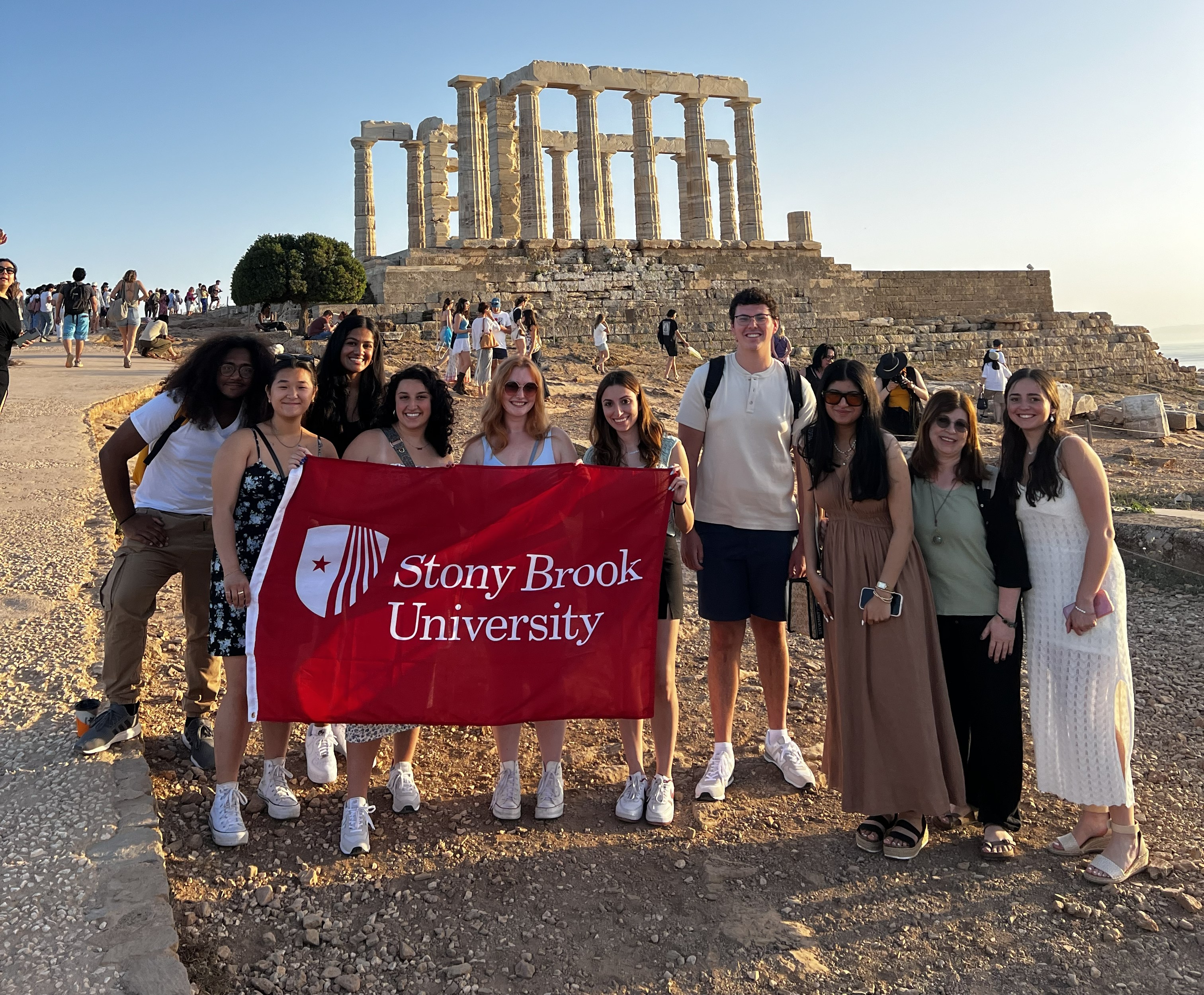 Group of students holding a flag that says "Stony Brook University