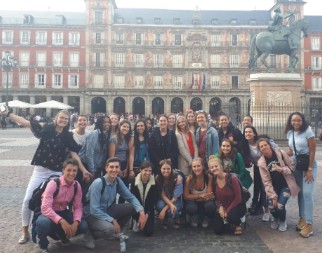 Group of students posing together in Madrid's Plaza Mayor.