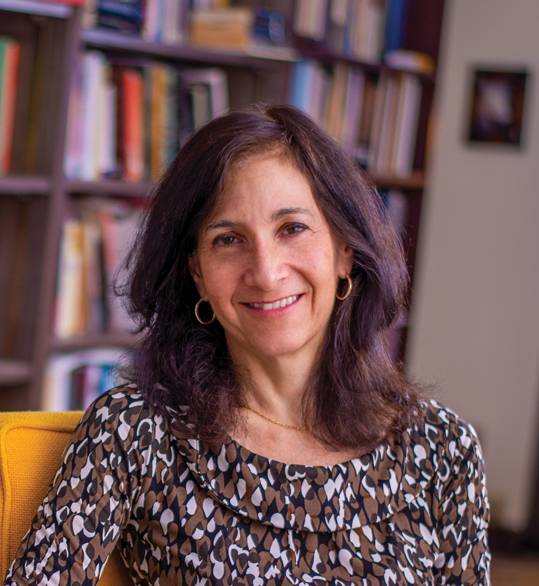 Headshot of Dr. Sara Lipton with shelves full of books in the background