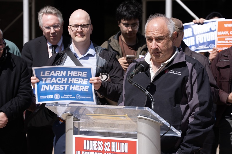 An employee representative speaking at a campus rally