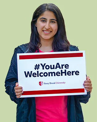 woman with welcome sign