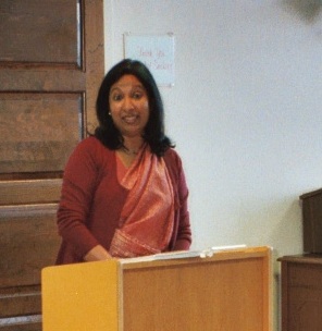 Meena Alexander speaking at a podium