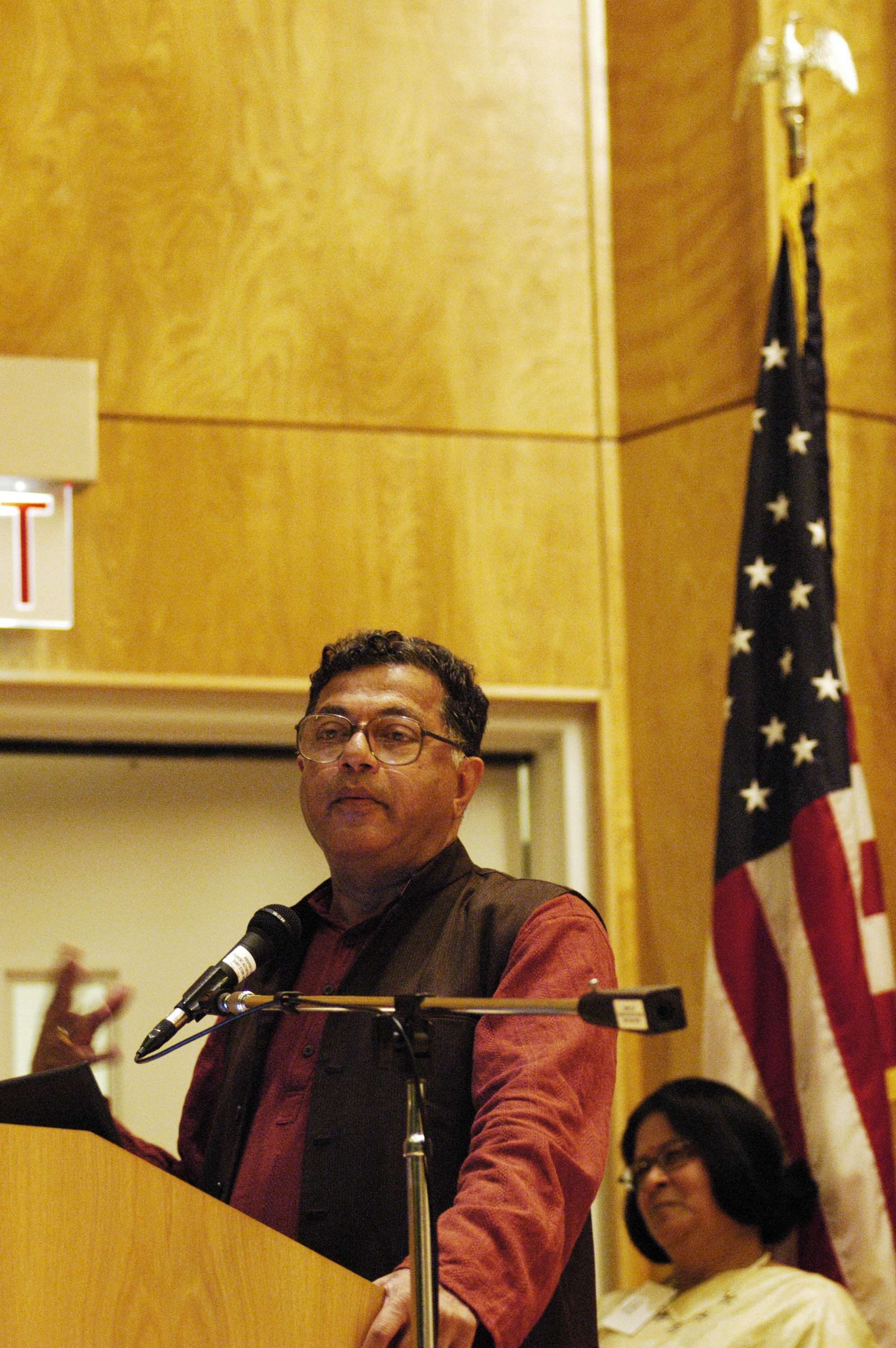 Professor speaking at a microphone