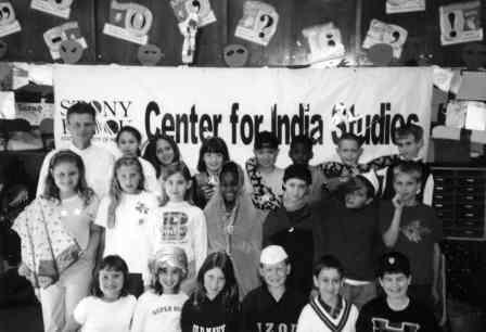 Black and white photo of kids standing in front of a sign that says "Center for India Studies"