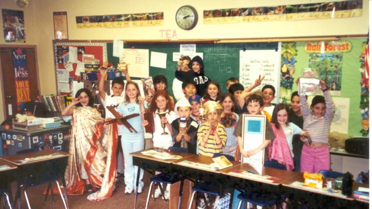 Group of kids making funny faces in a classroom