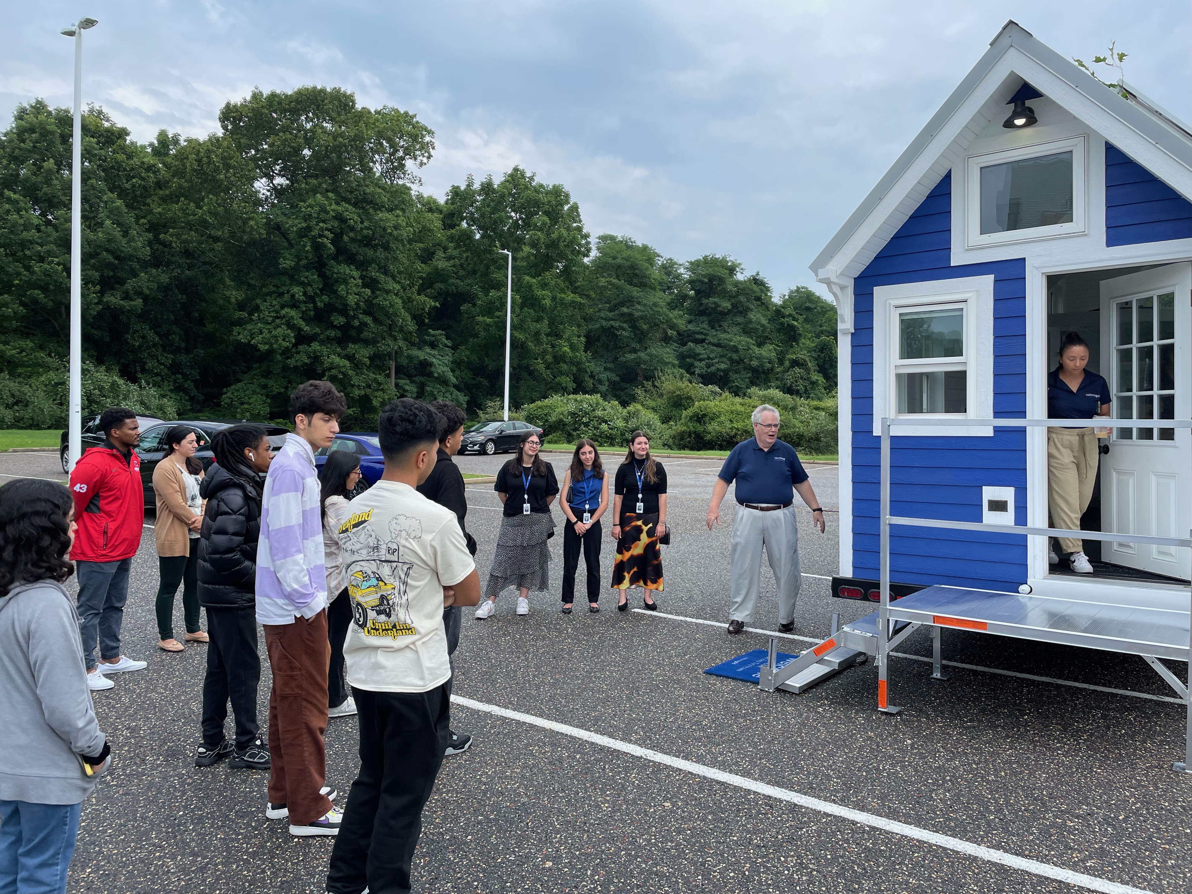 students at tiny home entrance