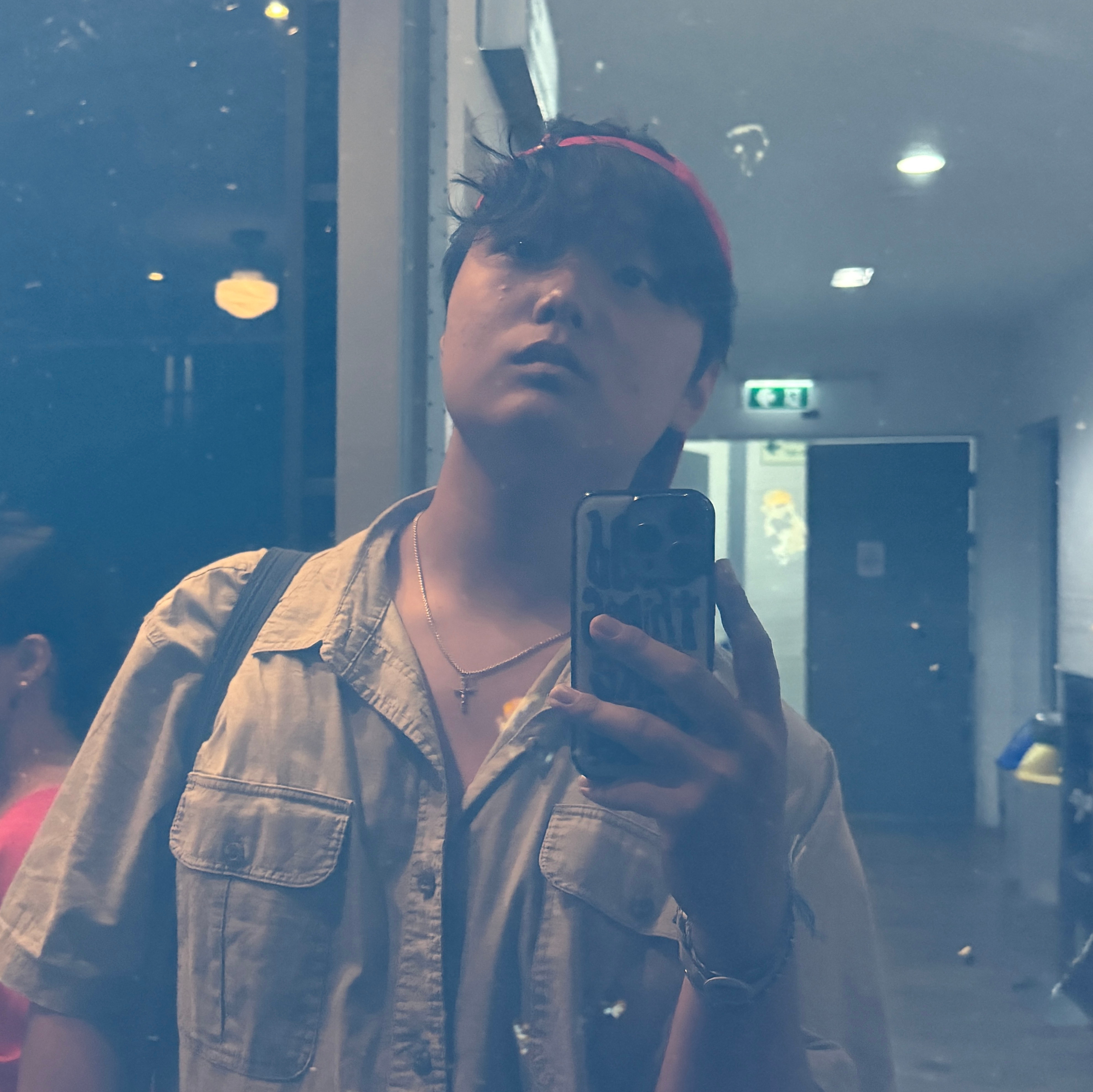 Man in backwards cap takes a mirror picture with phone