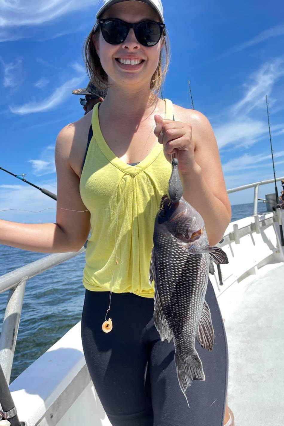 Person holding a fish on a boat