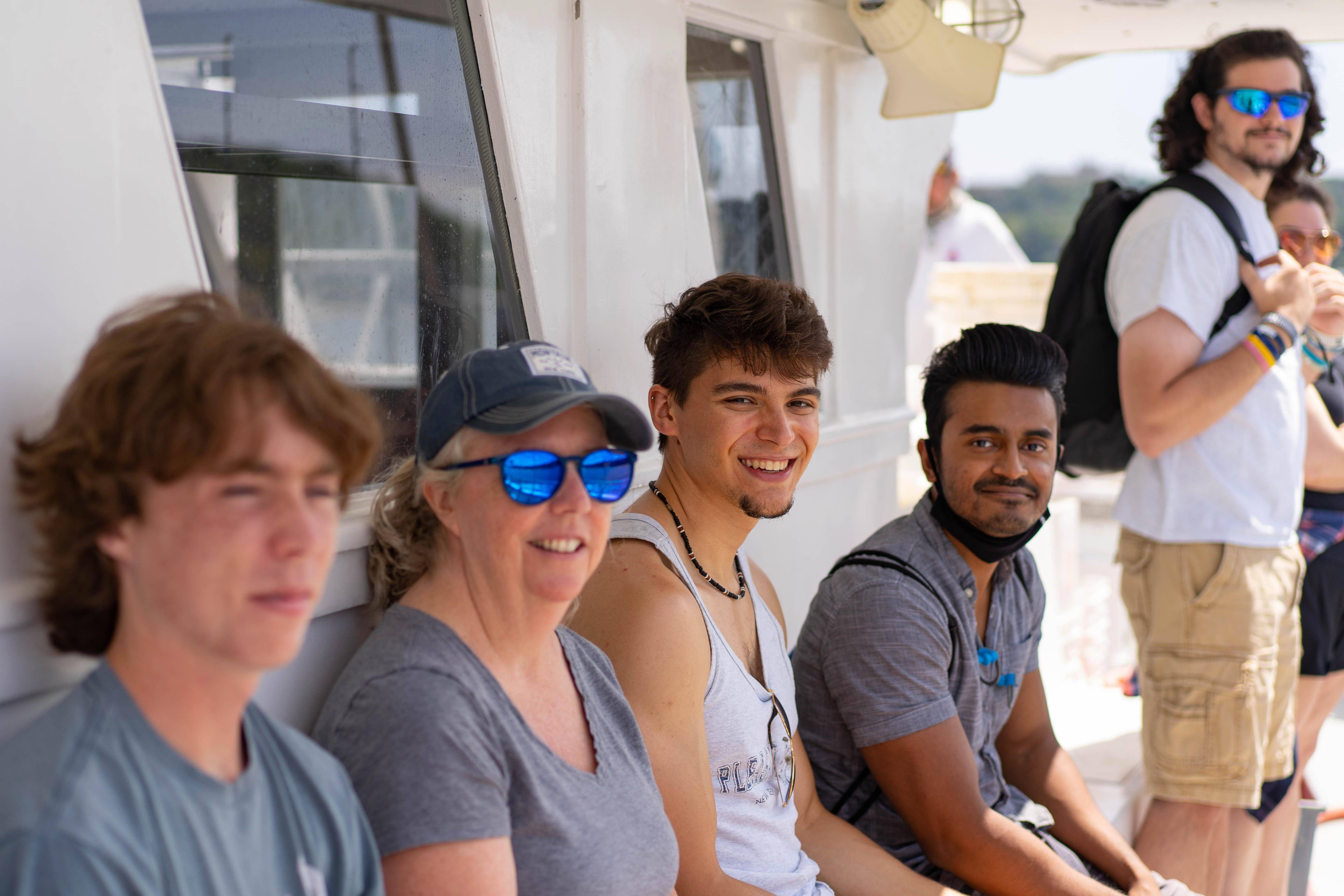 Five people smiling on a boat