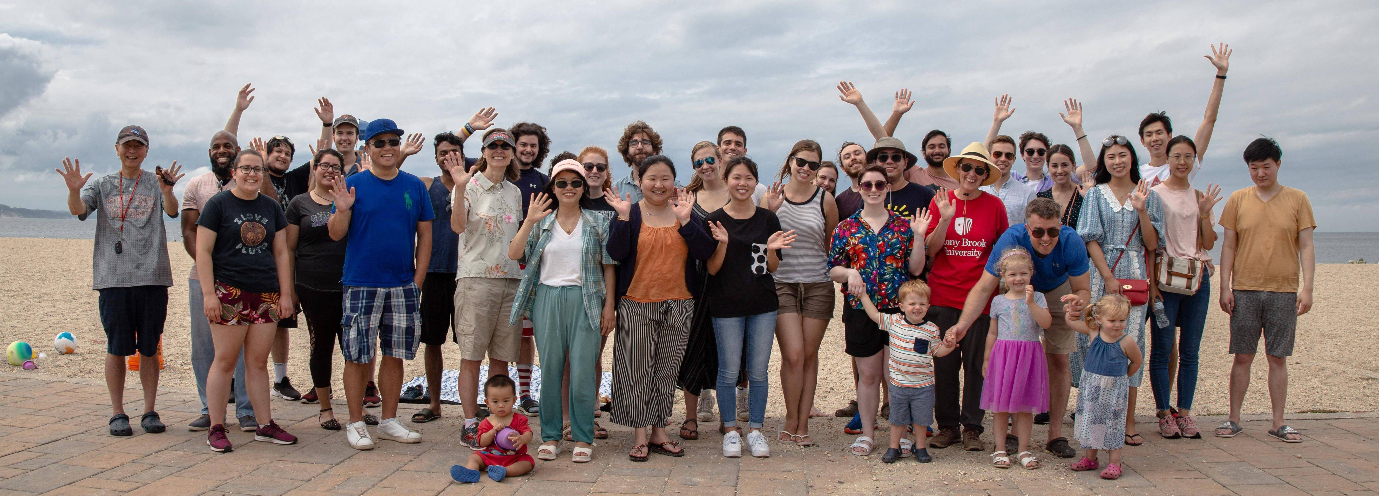 Group of people waving on the beach