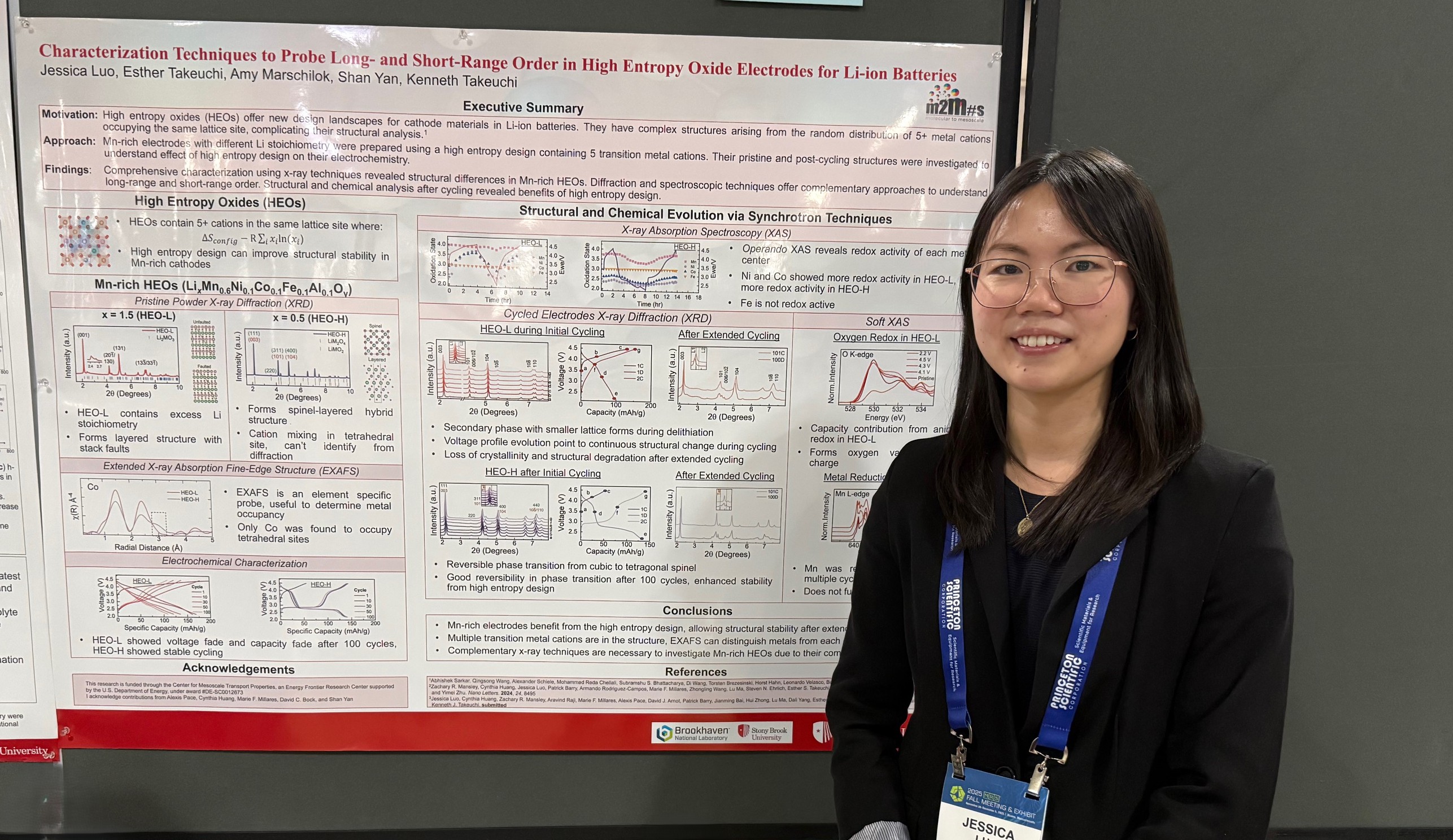 Student standing next to a poster