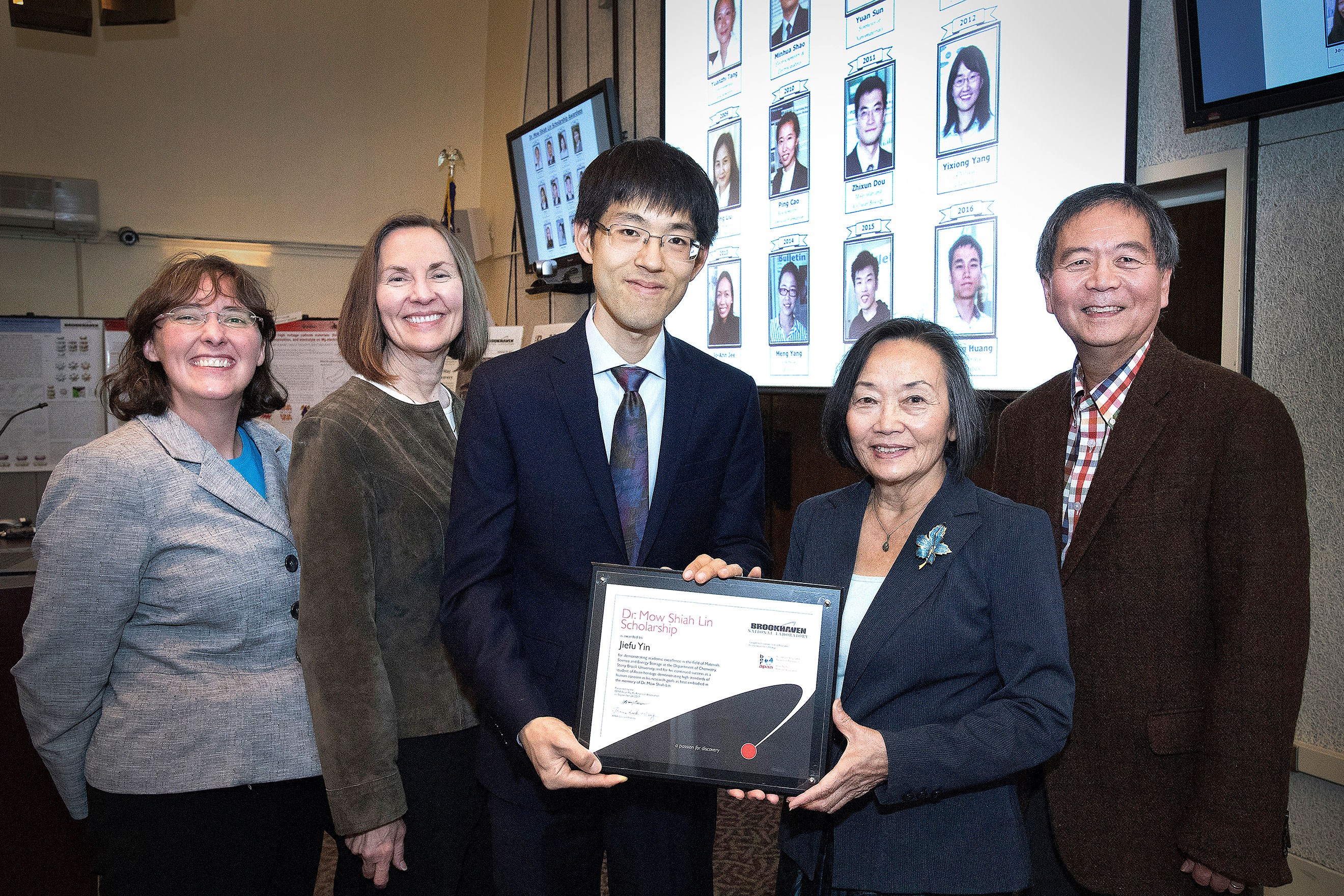 Five people holding a certificate