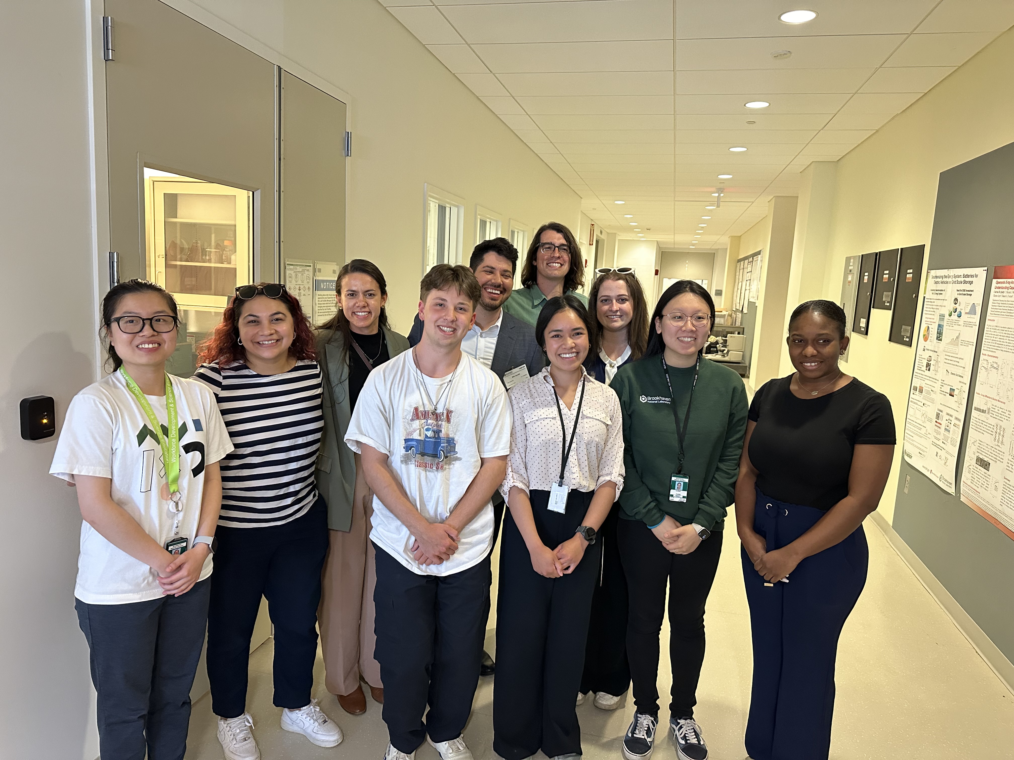 Group of people smiling in a hallway