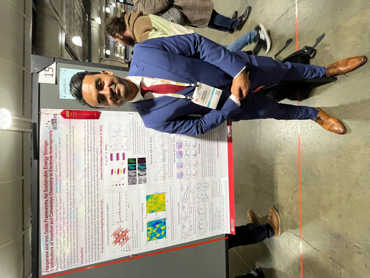 Student in a suit with a poster
