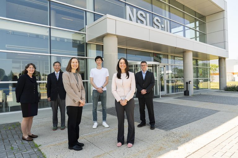 Group standing in front of the NSLS II building