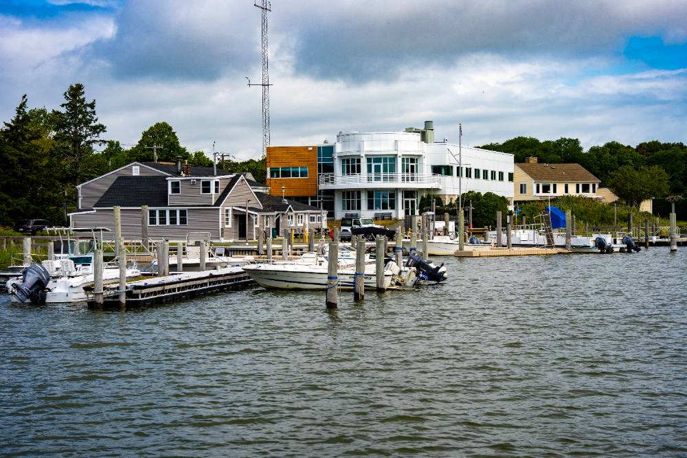 Marine Sciences Center on the water with an SBU boat docked in front