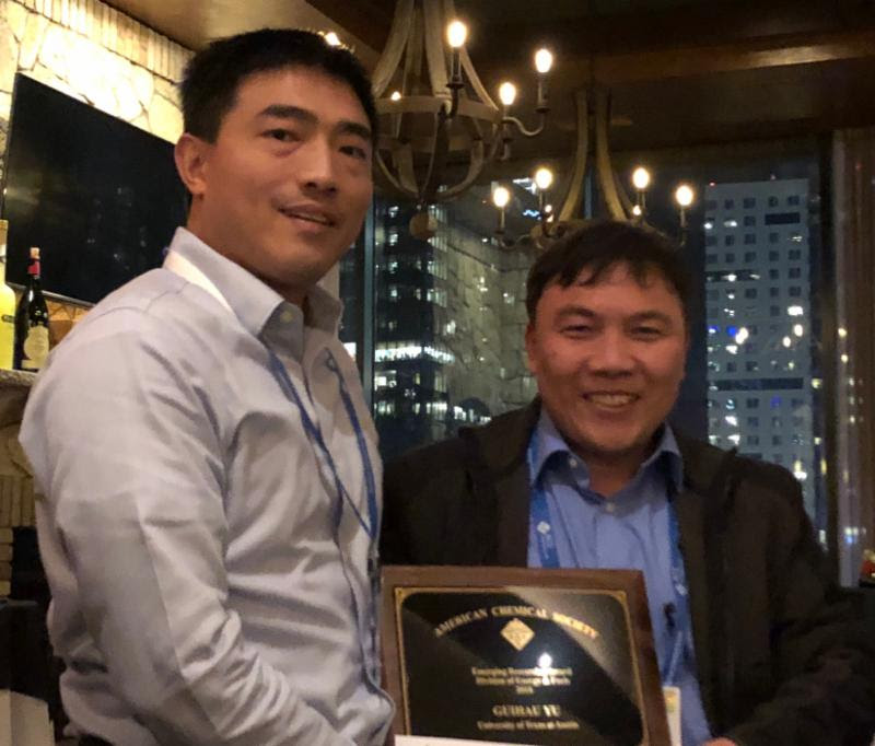 Professor and student holding an award