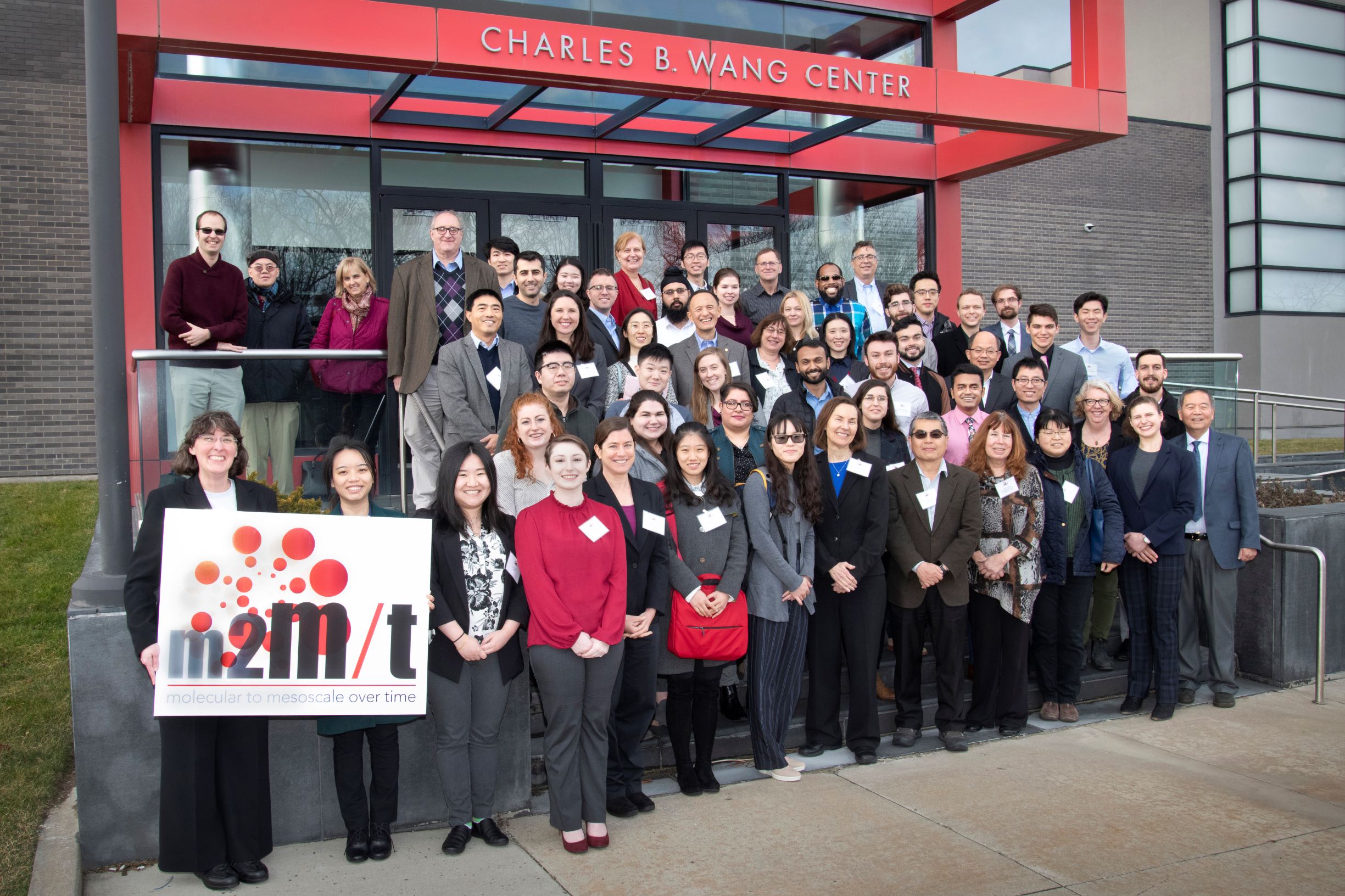 Large group holding an m2M sign