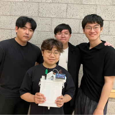 Students pose with a white medical device they designed for Senior Design 