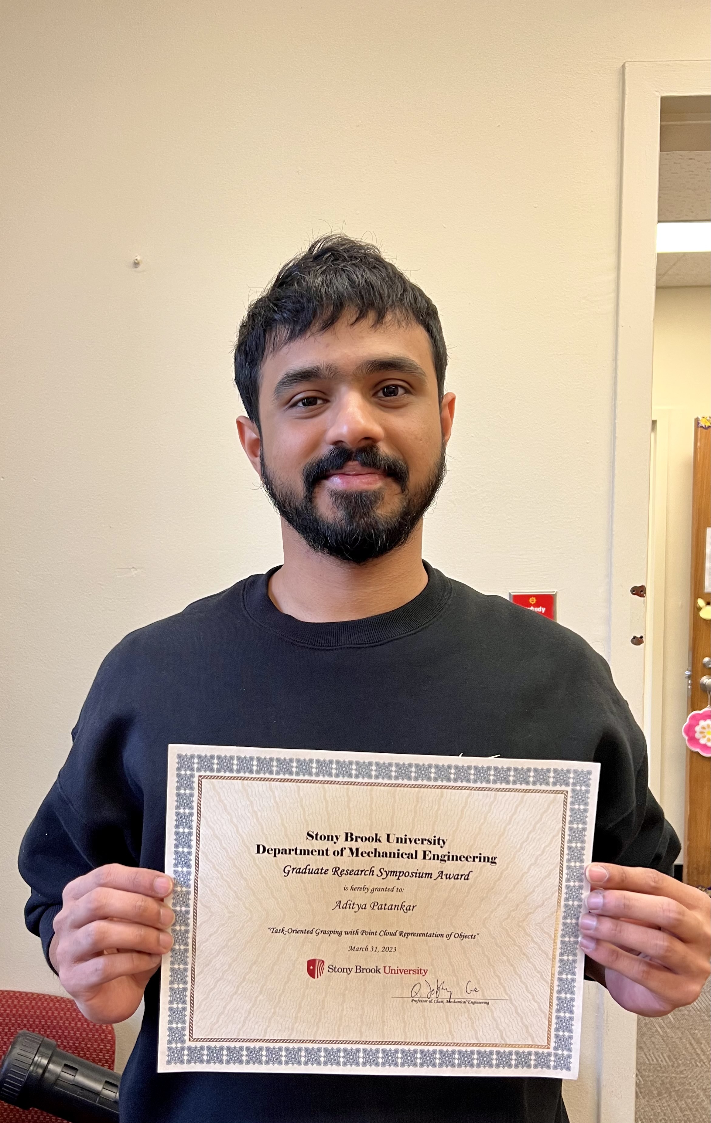 Graduate student, Aditya Patankar poses with certificate
