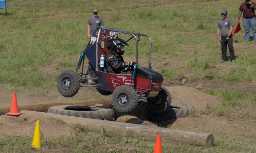 Car #99 is driven over obstacles