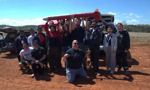 Members of the SBU Rocket Team pose with the Ultra-Deinde Rocket