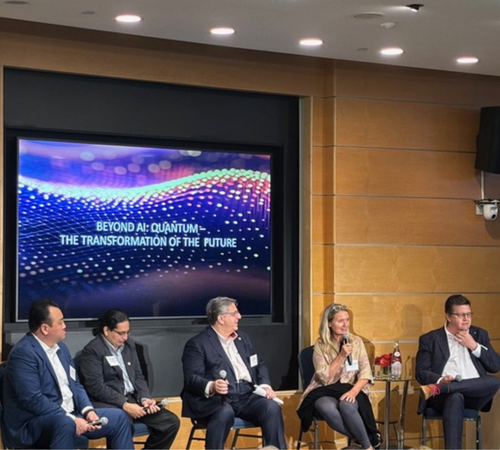 panelists seated in front of a screen that says Beyond AI: Quantum - The Transformation of the Future