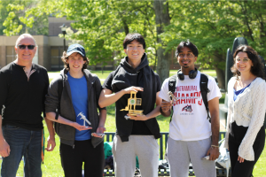 Instructors Joe Schurz and Leana Grotz pose with the winners of the race, who are holding trophies and their winning entries