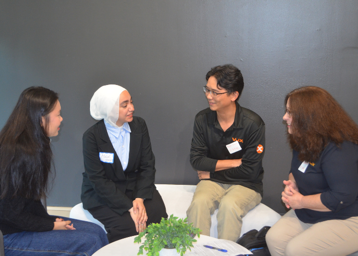 Students and Industry Partners chat around a table at the Friends of MEC Social.