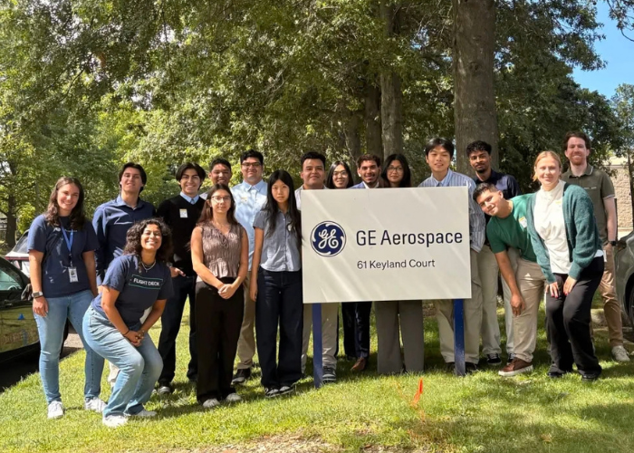 Group of Stony Brook AIAA students posing outdoors with a “GE Aerospace” sig
