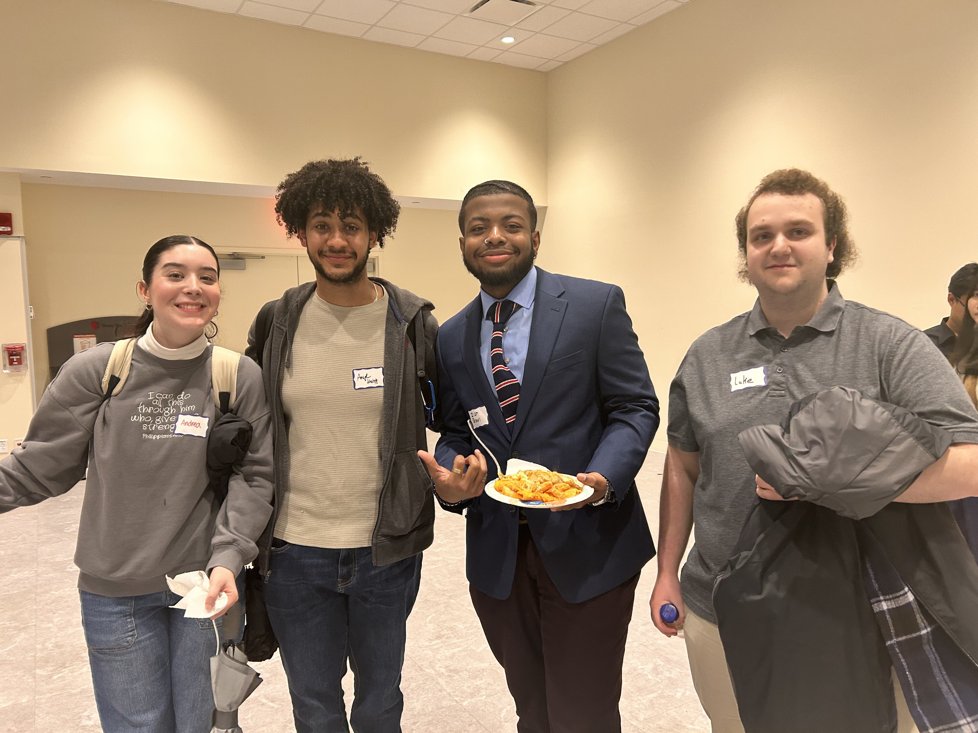 4 members of the ASME Student Chapter pose at the event