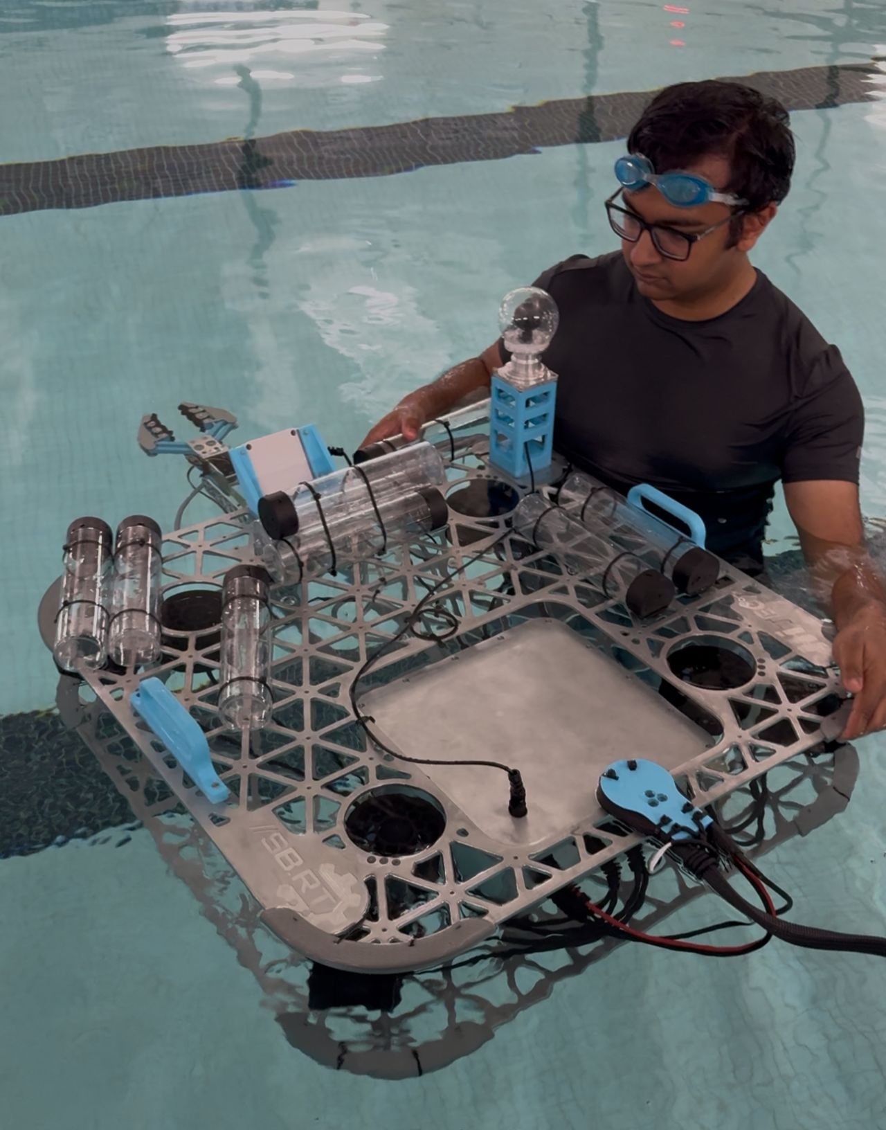Student in a pool with aquatic robot