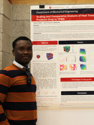 Student Taiwo Alare poses by his poster 