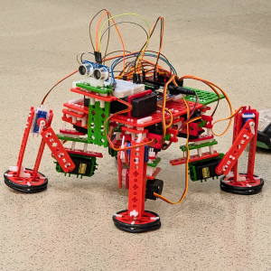 A four-legged orange and green SnappyXO robot