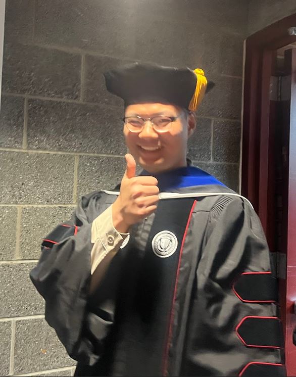 MEC Student, Xiaoqiang Xu in cap and gown 