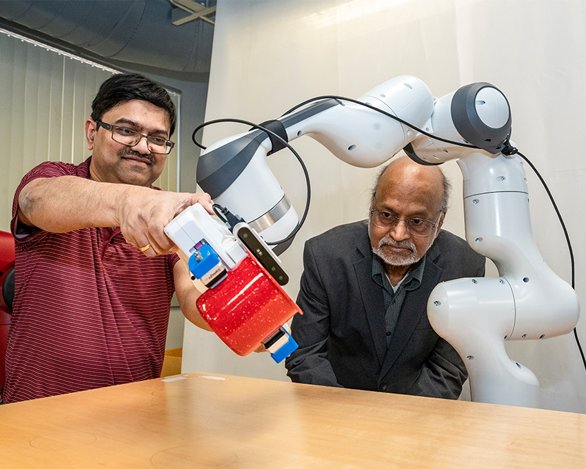 SBU Researchers teach a robotic arm how to pour liquid from a red cup