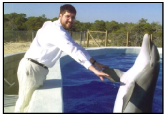 John Buck works with a dolphin in a pen