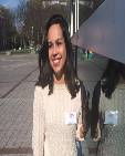 Adrienne Blaser; girl with medium length hair in white shirt standing by statue