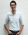Philippe Kimura-Thollander; Guy with black hair and glasses and wearing a collared shirt with hands in pant pockets