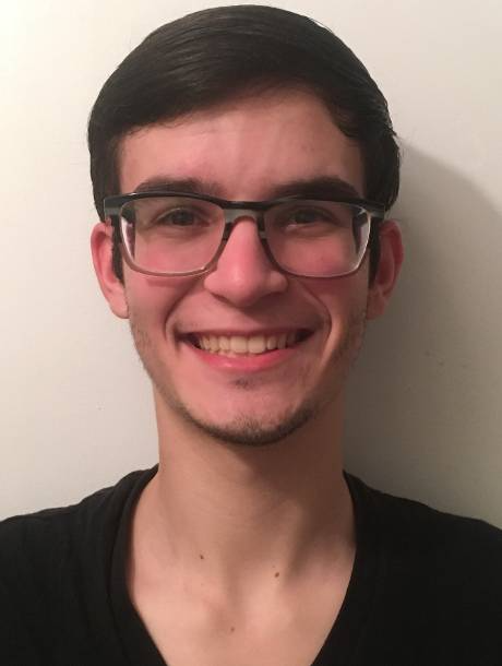 Headshot of Brian Tavares wearing square glasses and smiling