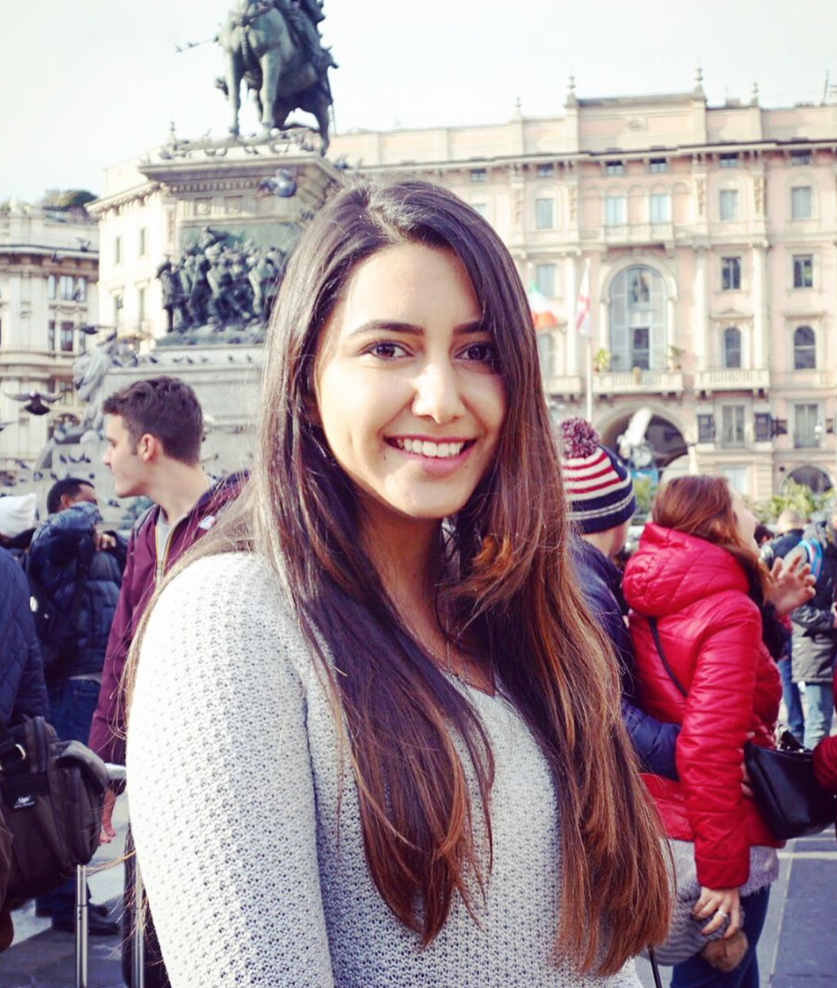Portrait shot of Jasmeet Kaur with long brown hair and gray knit shirt