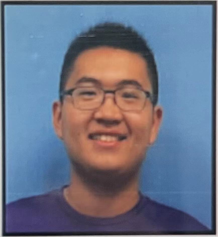 Close up shot of Andrew Liu wearing square glasses and blue shirt